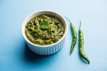 Healthy Indian Green Chutney or Sauce Made using Coriander, Mint And Spices. isolated over moody background. Selective focus