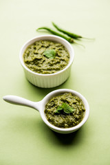 Healthy Indian Green Chutney or Sauce Made using Coriander, Mint And Spices. isolated over moody background. Selective focus