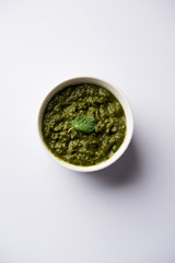 Healthy Indian Green Chutney or Sauce Made using Coriander, Mint And Spices. isolated over moody background. Selective focus