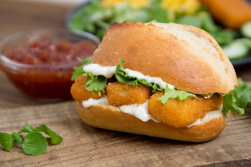 Sandwich with Fish Sticks selective focus on an old wooden table