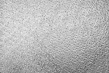 Structural glass surface in black and white. Fine texture on the glass have geometric shapes.