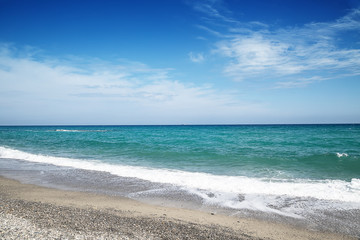 Fototapeta na wymiar Pebble beach and blue sky on background
