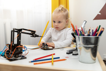 robotics - child playing with robot arm