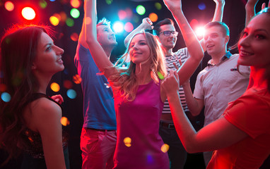 Group of young people having fun dancing at party.