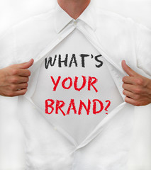 Man opens his shirt to reveal the words: What's Your Brand?