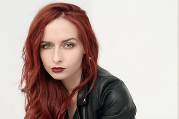 Portrait of attractive red haired young woman with blue eyes.