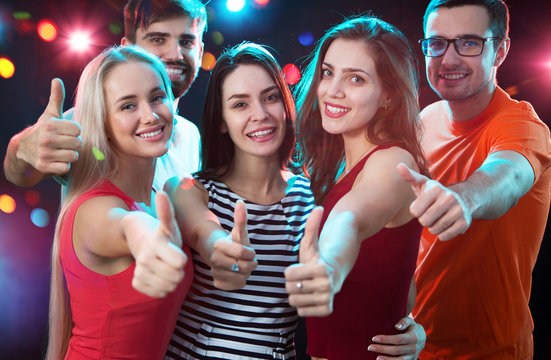 People showing OK sign in the night club