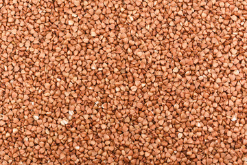 Background of buckwheat grains. Buckwheat texture. Close up