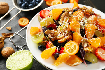 Delicious fresh salad with walnuts on plate