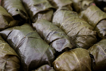 Fototapeta na wymiar Dolma, stuffed grape leaves with rice and meat. Top view. Delicious and healthy food.