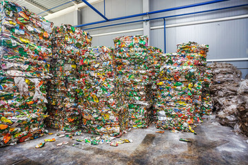 Plastic bales of rubbish at the waste treatment processing plant. Recycling separatee and storage of garbage for further disposal, trash sorting. Business for sorting and processing of waste.