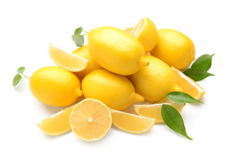 Pile of fresh whole and cut lemons on white background
