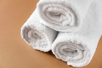 Soft towels on color background, closeup