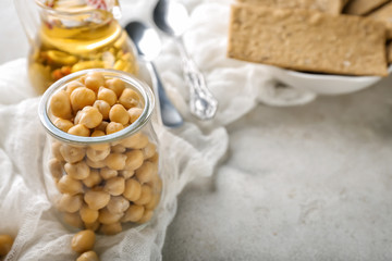 Jar with chickpeas on grey table