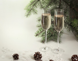 two glasses with champagne and gift on the Christmas background