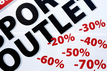 signs on shop window indicate sale and discount percentages