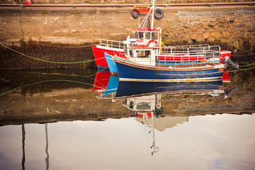 Old wooden colored boat moored (Ireland)