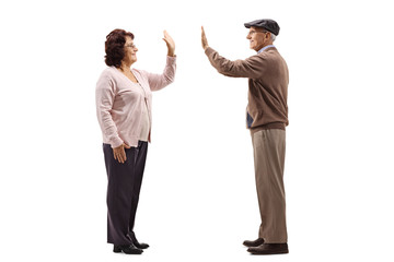 Senior woman high-fiving a senior man