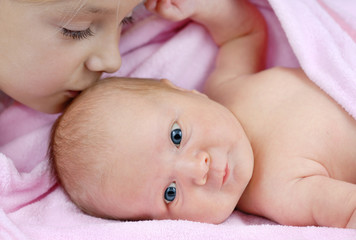 Baby girl lying on a pink blanket