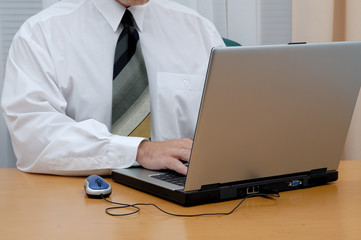 Young businessman in a white shirt with laptop