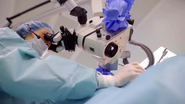 female professor doctor is trying experimental method of curing of hearing diseases by surgery