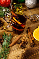Obraz na płótnie Canvas Christmas mulled wine with spices and Christmas decoration on wooden table