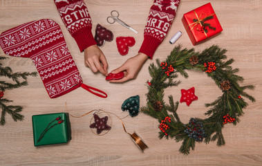 crop woman working on christmas decoration