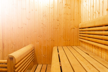 Interior of Finnish sauna, classic wooden sauna, Finnish bathroom. Wooden sauna cabin. Wooden room. Sauna steam. Soft lighting