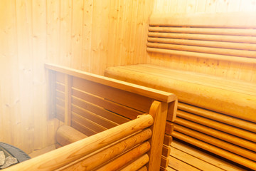 Fototapeta na wymiar Interior of Finnish sauna, classic wooden sauna, Finnish bathroom. Wooden sauna cabin. Wooden room. Sauna steam. Soft lighting