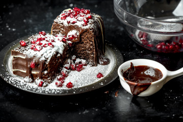 sweet moments - brownies poured hot, liquid chocolate, sprinkled with red pomegranate seeds and powdered sugar
