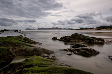 Rocks on a beach near Cape Reinga at dusk, North Island, New Zealand