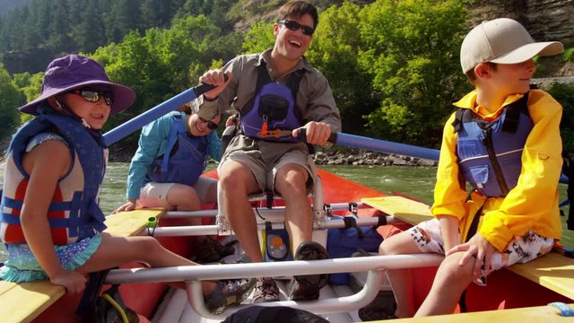 Caucasian family having fun together rafting on Colorado River on holiday