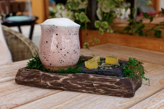 Clay glass with cocktail on restaurant table
