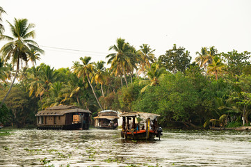 A beautiful houseboat is sailing among Alleppey's backwaters, Kerala, India.