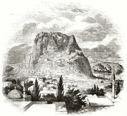 ancient medieval middle oriental city at the foot to a rocky mountain with sea on background. Afyonkarahisar Turkey. By unidentified author published on Magasin Pittoresque Paris 1839