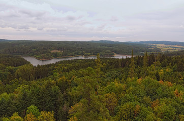 Aerial view to the Landstejn Water Reservoir in the forest. Scenic view from the tower of the Landstejn castle. Cloudy summer day
