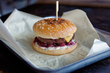 Burger with sour marinated cherry, unhealthy food