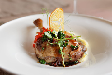 Fried duck leg with molecular caviar, close-up