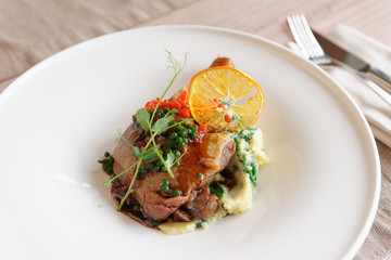 Fried duck meat on porcelain plate