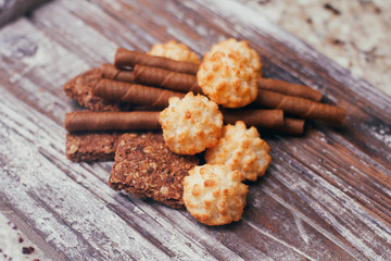 Set of different confectionery sweets on wooden table. Chocolate, waffles, coconut biscuits, cookies. 