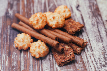 Set of different confectionery sweets on wooden table. Chocolate, waffles, coconut biscuits, cookies. 