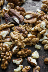 Pile of peeled walnuts on metal background