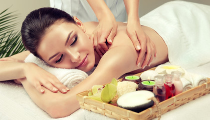 Fototapeta na wymiar Massage and body care. Spa body massage woman hands treatment. Woman having massage in the spa salon for beautiful girl 