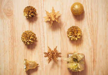 golden pine cones glittered christmas and gift box decoration on wood table background. copy space.