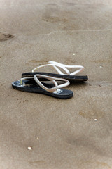 Fototapeta na wymiar flip flops ,beach sandals in the sand