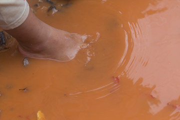 Fototapeta premium asian boy feet in dirty water
