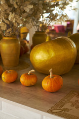 beautiful autumn composition with pumpkins. autumn cozy still life. pumpkins, autumn leaves on wooden background. soft focus side view