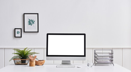 Desktop screen business life white desk folder and frame on the wall. interior decoration.