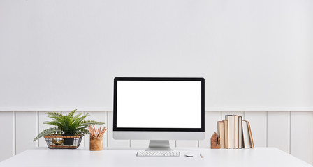 Desktop and computer screen white desk and pencil. White office wall.