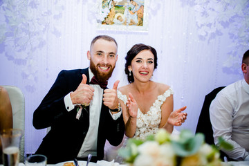 Happy brides sitting at the table